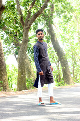 Fototapeta premium Man wearing a purple Punjabi dress standing on a road unique photo