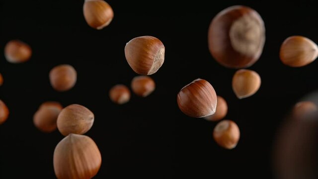 Hazelnuts in Shells Flying on the Black Background in Slow Motion 1000fps (Phantom Flex)