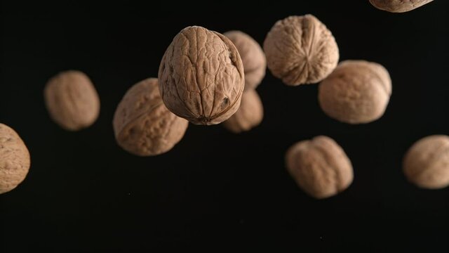 Walnuts in Shells Flying on the Black Background in Slow Motion 1000fps (Phantom Flex)