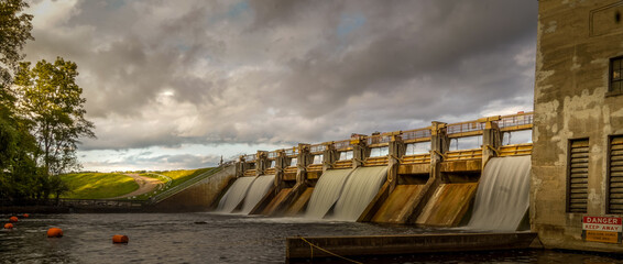 Water flowing over Barton dam on a cloudy morning