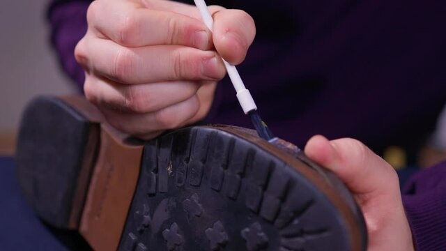 glue application with a brush, shoe repair.