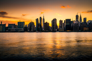 Panoramic view of the New York City skyline silhouette at sunset
