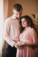 pregnant woman and man in arms posing in a classic interior.expecting a baby. pregnancy