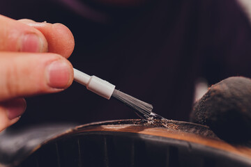 glue application with a brush, shoe repair.