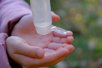 little girl sanitizing her hands