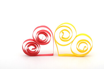 two quilling paper hearts, red and yellow