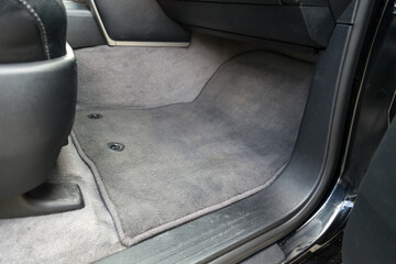 Car mat in the front passenger seat made of beige fabric material in the service after dry cleaning...