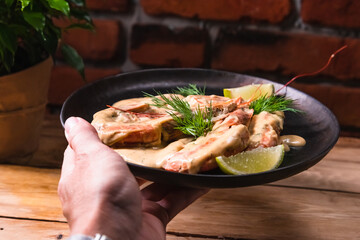 Delicious fried langoustines in sauce on a black plate, prepared in an Asian style. Fast and ready meal concept