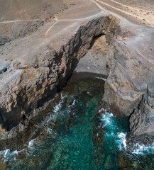 Aerial view of the jagged shores and beaches of Lanzarote, Spain, Canary. Roads and dirt paths. Walking routes to explore the island. Bathers on the beach. Atlantic Ocean. Papagayo