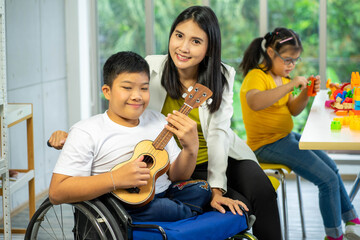 disability kid on wheelchair with Autism child in special classroom