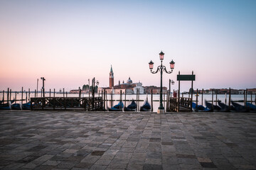 Gondolas with church of San Giorgio Maggiore in Venice, Italy on the island in the logoon