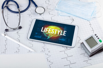 Tablet pc and medical tools with LIFESTYLE inscription, social distancing concept