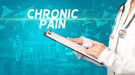 doctor writes notes on the clipboard with CHRONIC PAIN inscription, medical diagnosis concept