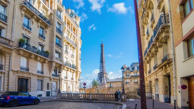 4k timelapse video of the cozy street with view of Eiffel Tower in Paris.Romantic view from a small paris street on a cloudy autumn day in spring summer - wide horizontal panorama