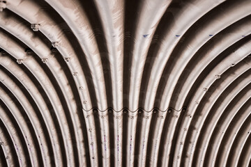 Inside of a large tube with symmetrical folds, made of metallic material.