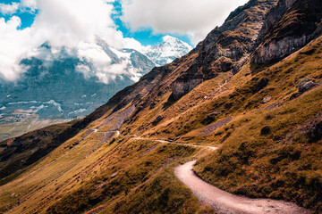 A small hiking high up in the Bernese Alps with famous mountains Eiger and Jungfrau in the...