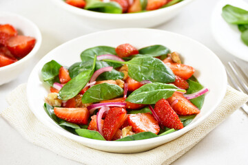 Healthy breakfast with fruit salad from strawberry, spinach and walnut