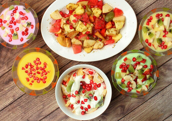 set of healthy fresh fruit salad on wooden background. Top view.