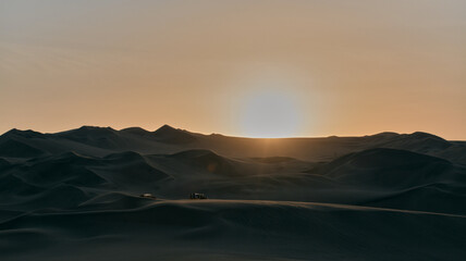 Fototapeta na wymiar Sunset in the huacachina desert in Peru