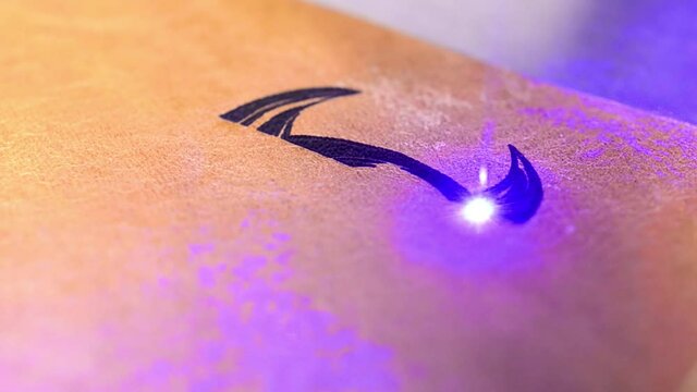 Laser engraving a sign on leather