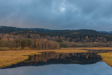 Fototapeta na wymiar End of Lipno sea reservoir in autumn cloudy color morning