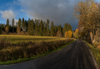 Sunrise near forest and road to centre of national park Sumava