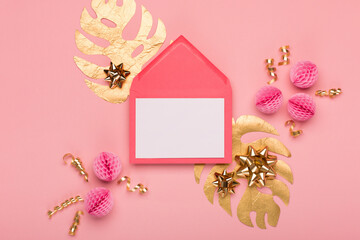 Golden tropical leaves Monstera, festive gift box, gold and pink decorations on amaranth pink background.