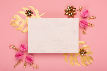 Golden tropical leaves Monstera, festive gift box, gold and pink decorations on amaranth pink background.