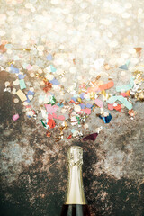happy New Year. New Years Eve celebration concept background.Champagne bottle with confetti