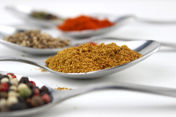 Wide variety spices and herbs on background of white table, with empty space for text or label.