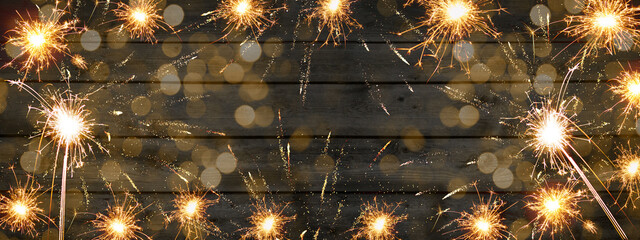 Silvester / new year background banner panorama long- Sparklers, firework and bokeh lights on...