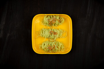 Jade Noodle on yellow plate  with black background