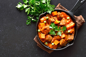 Beef stew with potatoes and carrots in tomato sauce