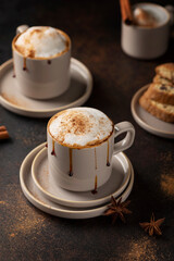 Hot winter cappuccino with cinnamon and caramel