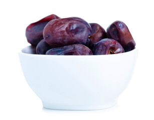 dried dates fruit in bowl on white background isolation