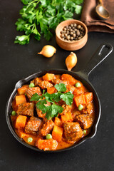 Beef stew with potatoes and carrots in tomato sauce
