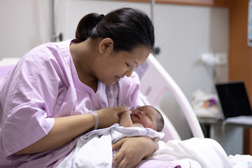 New Born Baby Girl Is Holding onto Mother's Finger