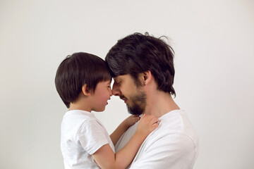 father and son on a white background at home