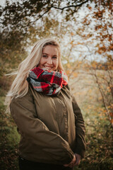 Girl in autumn forest nature with brown colors