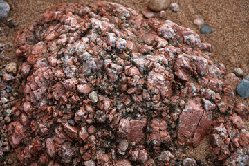 Untreated granite surface destroyed by atmospheric phenomena, shot close-up in natural environment