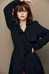 Naklejka premium Sexy lady dark coat elegant style rejoicing on an isolated background 