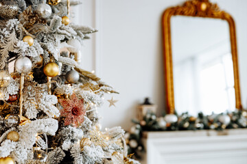 Decorated Christmas tree on a blurry light background. close up.