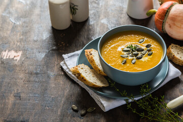 pumpkin and carrot cream soup with pumpkin seeds and toasted bread
