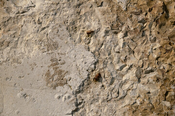 Fototapeta premium Close-up shot of a concrete surface partially destroyed by atmospheric phenomena