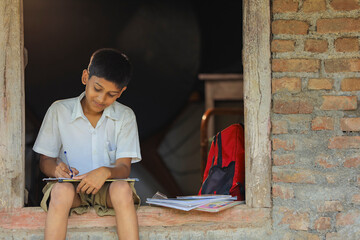 Fototapeta na wymiar Cute indian child studying at home