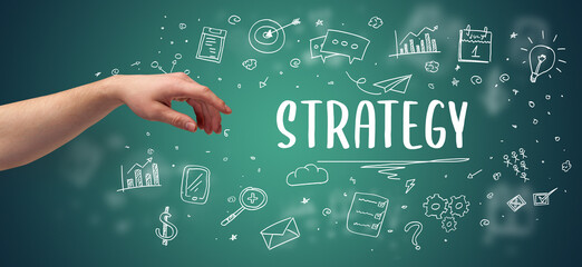 Close-Up of cropped hand pointing at STRATEGY inscription, modern business solution concept