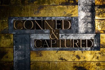 Conned and Captured text message on vintage textured grunge copper and gold background