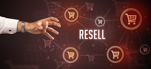 Close-Up of cropped hand pointing at RESELL inscription, online shopping concept