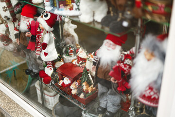 Stylish santa claus, reindeer and other festive christmas toys in window store