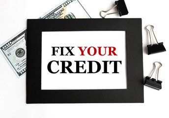fix your credit, text on white paper in black frame on light background